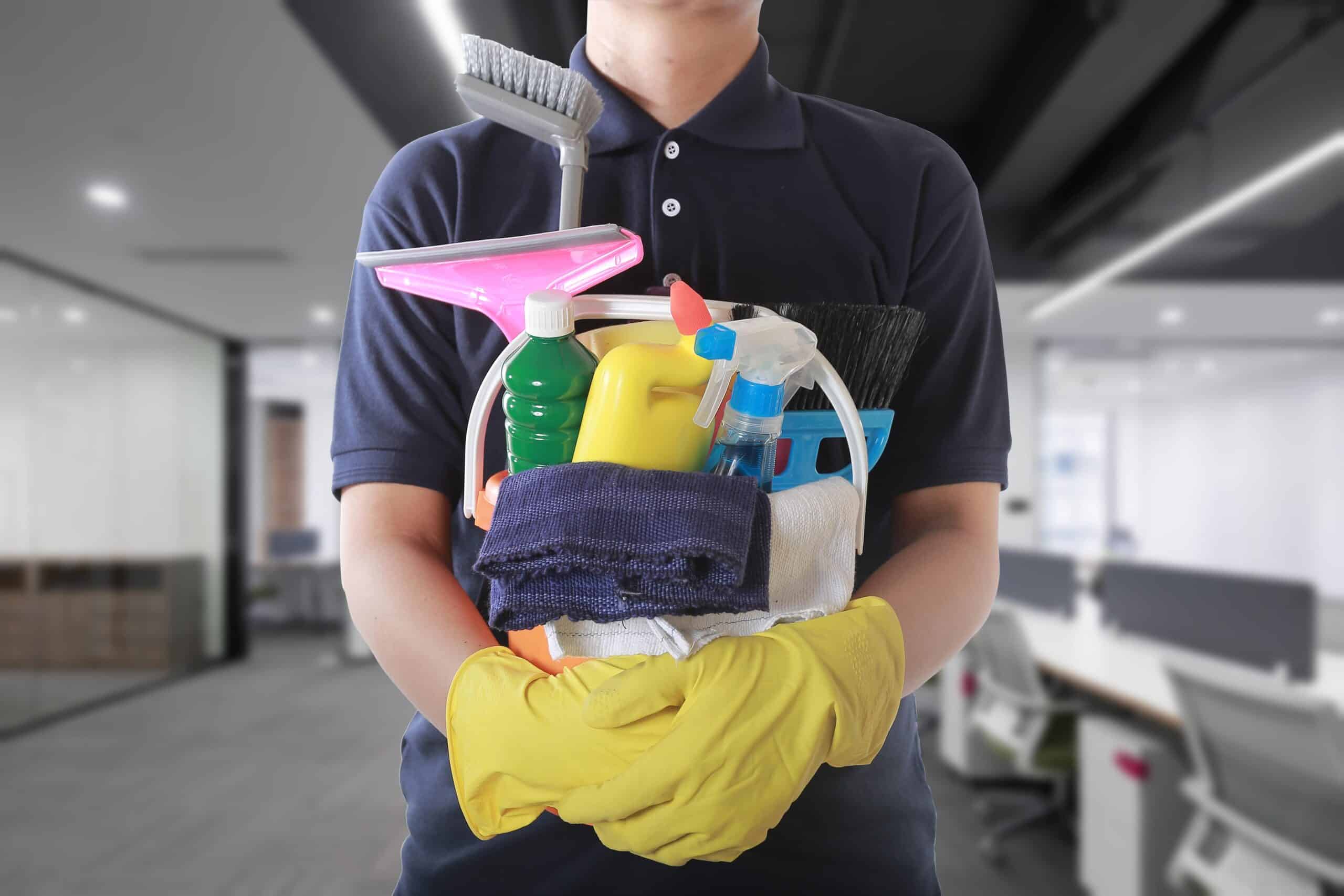 A man holding a commercial cleaning kit, ready to start his cleaning tasks.
