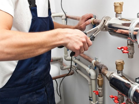 Man completing ordinary maintenance on a pipe