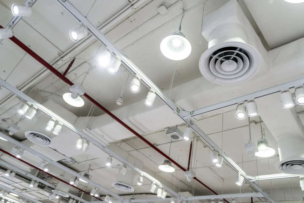 A ceiling featuring multiple lights and a fan, highlighting the area for air duct cleaning.