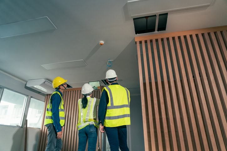contractors conducting building maintenance using predictive maintenance tools
