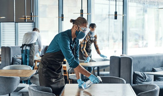 Commercial cleaners cleaning a cafe