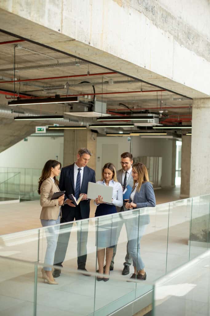 FM teams working collaboratively with in-house facilities management teams for cost-saving strategies in facilities